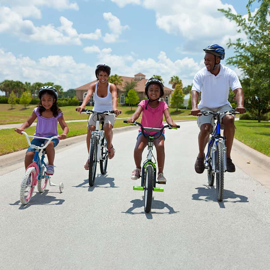 A family riding bicycles on a road